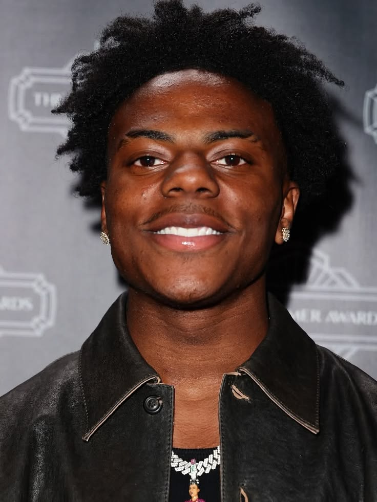 ishowspeed close-up portrait with afro hair and diamond earrings